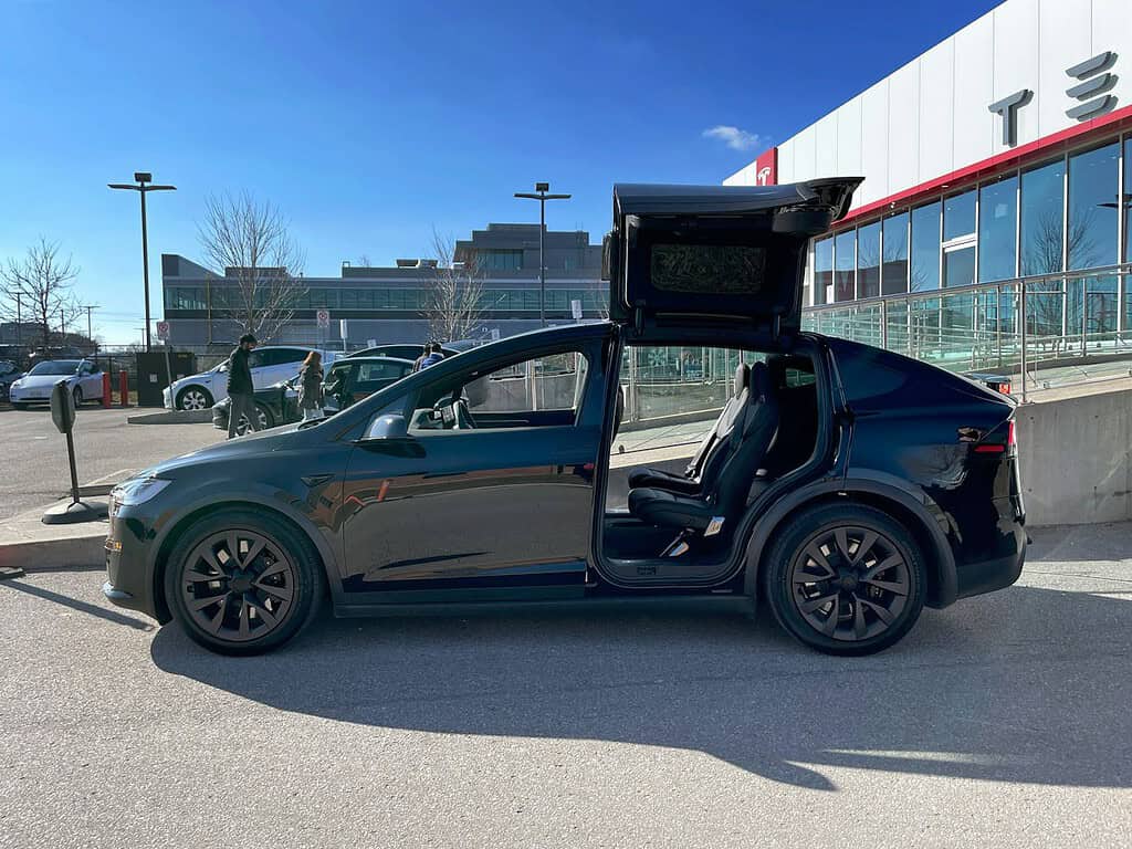 Illustrative archival photograph: Tesla Model X falcon wing doors open. Photo by Robbie on Unsplash; not an image of the October 2026 announcement.