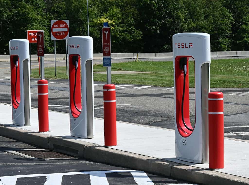Illustrative archival photograph: Tesla Supercharger row reference. Photo by J Dean on Unsplash; not an image of the October 2026 announcement.